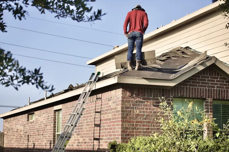 Professional roofer working on a residential roof in Hovey Corner